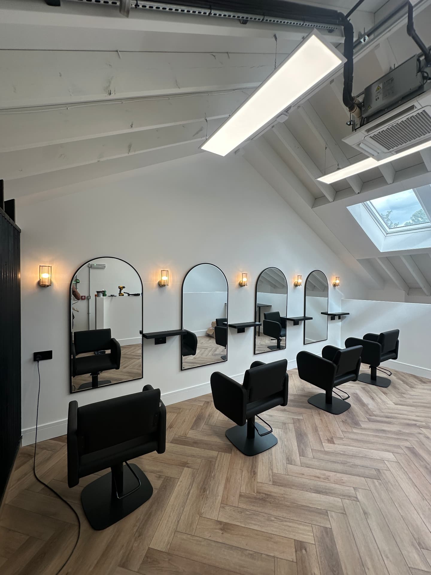 Loft salon fit-out with wall lights, mirrors and LED panels